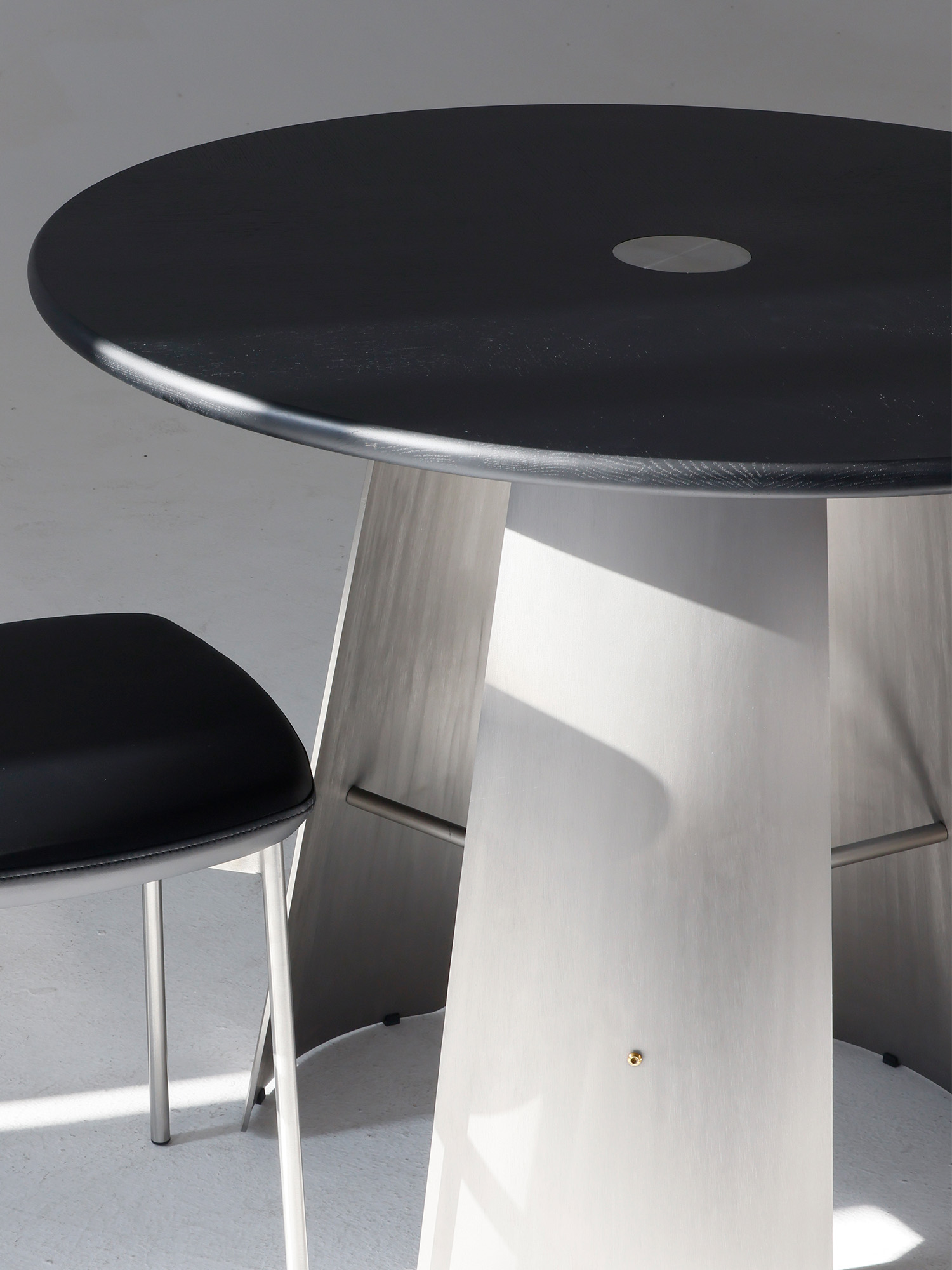 Monet Round Table-wood top 17 Monet dark tabletop with brushed steel pedestal detail