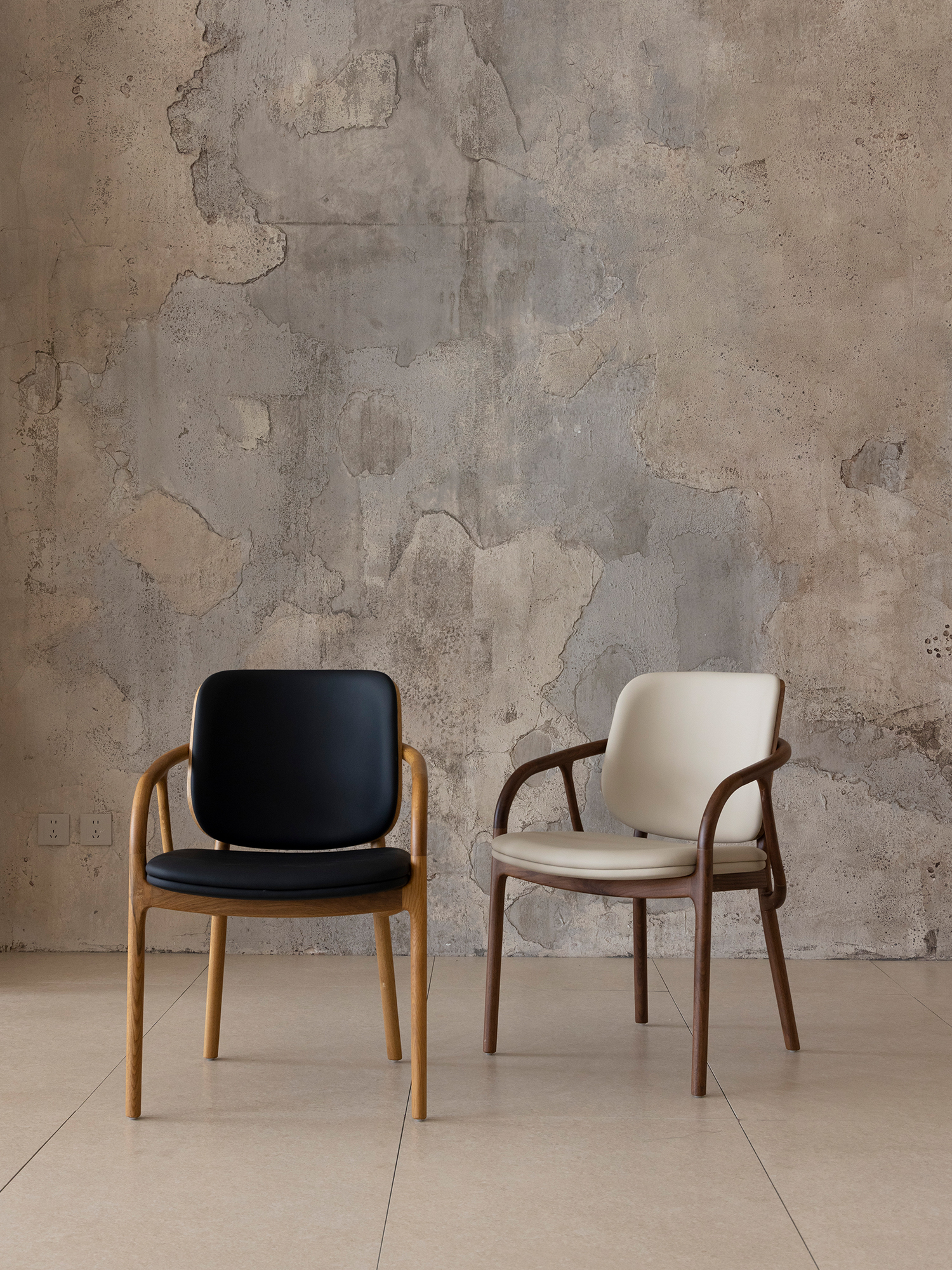 Mufan chair 19 Mufan armchairs in black and off-white upholstery display