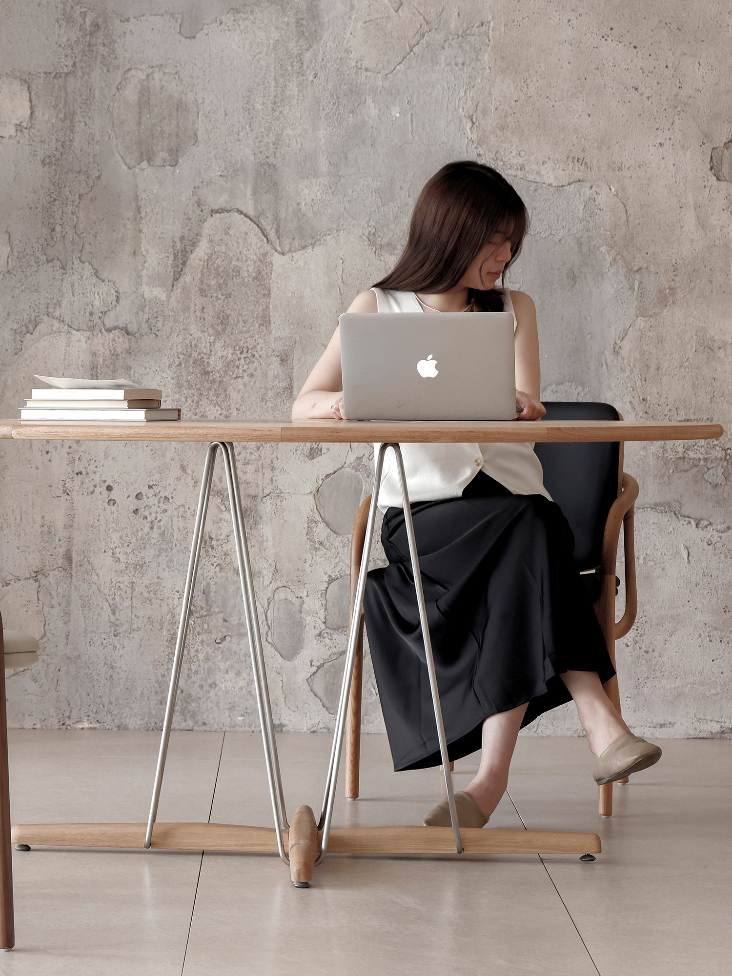 Pebble dining table 20 Pebble dining table in workspace with seated person