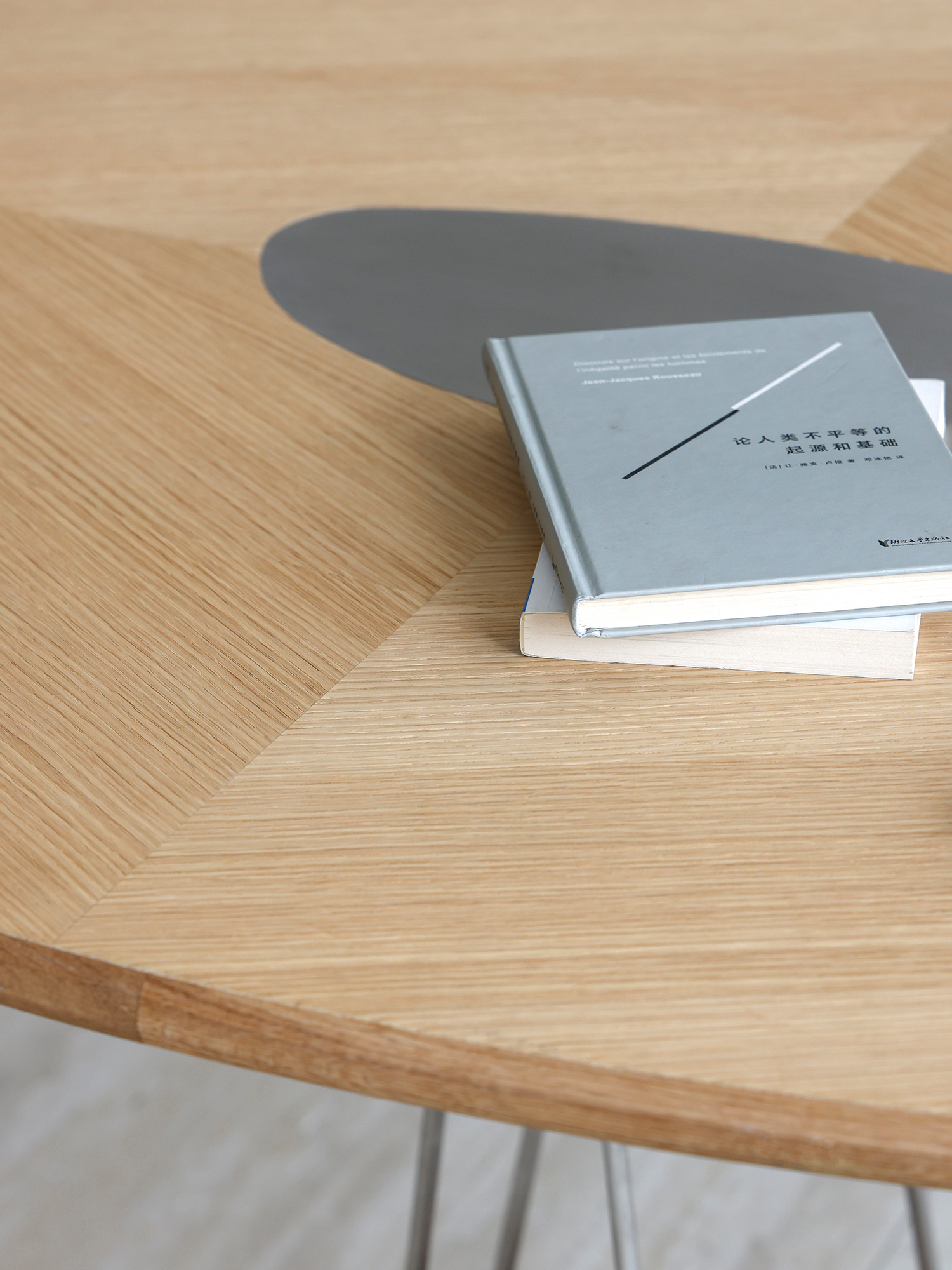 Pebble dining table 17 Pebble oak veneer tabletop with central steel inlay