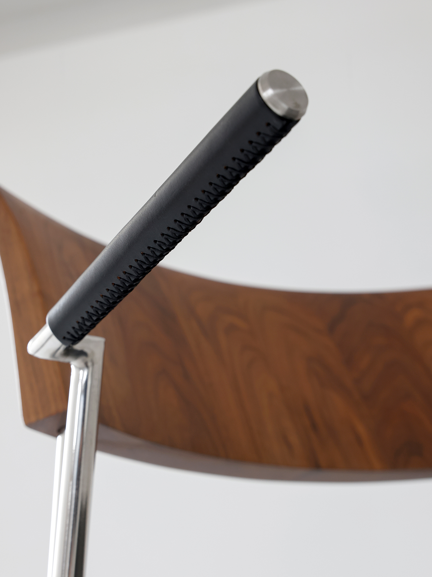 Shuge chair 18 Shuge black arm pad and stainless steel frame close-up
