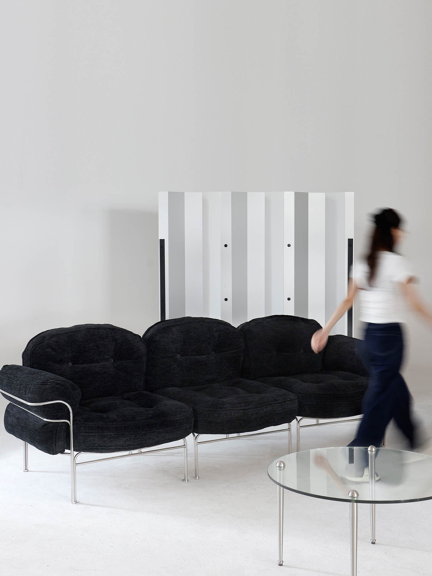 Layeredwave Screen 16 Wave Screen creating separation beside a black lounge sofa