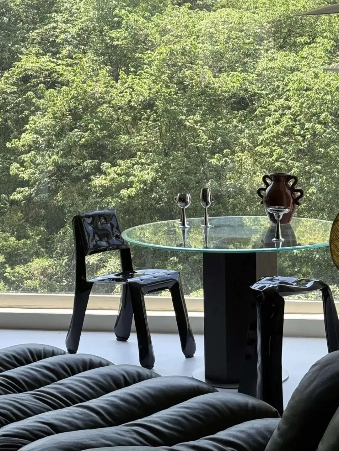 Furniture by the Window 17 Round dining table and chairs facing the trees outside