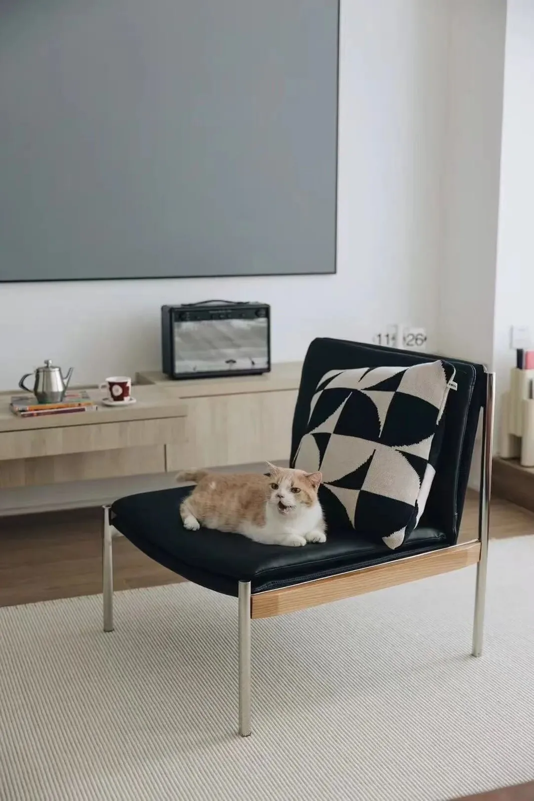 A Home Shared with Cats 14 Cat sitting on a Bauhaus Armchair in a calm home interior