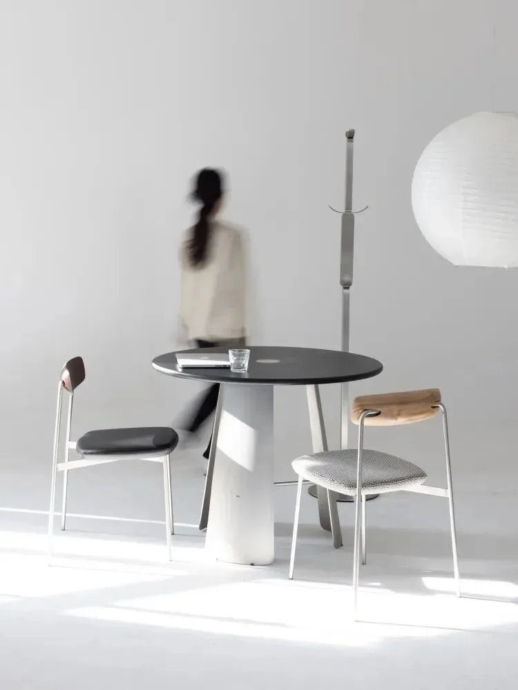 Restaurant Table Sizes and Seating Capacity Guide 18 Black round dining table in a bright minimalist room