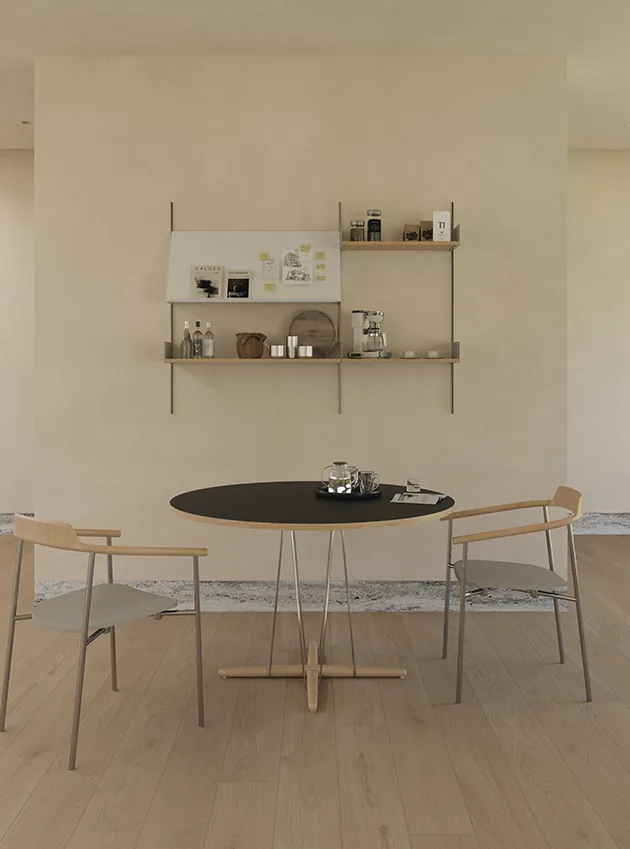 Restaurant Table Sizes and Seating Capacity Guide 16 Dark round dining table in a minimal open interior
