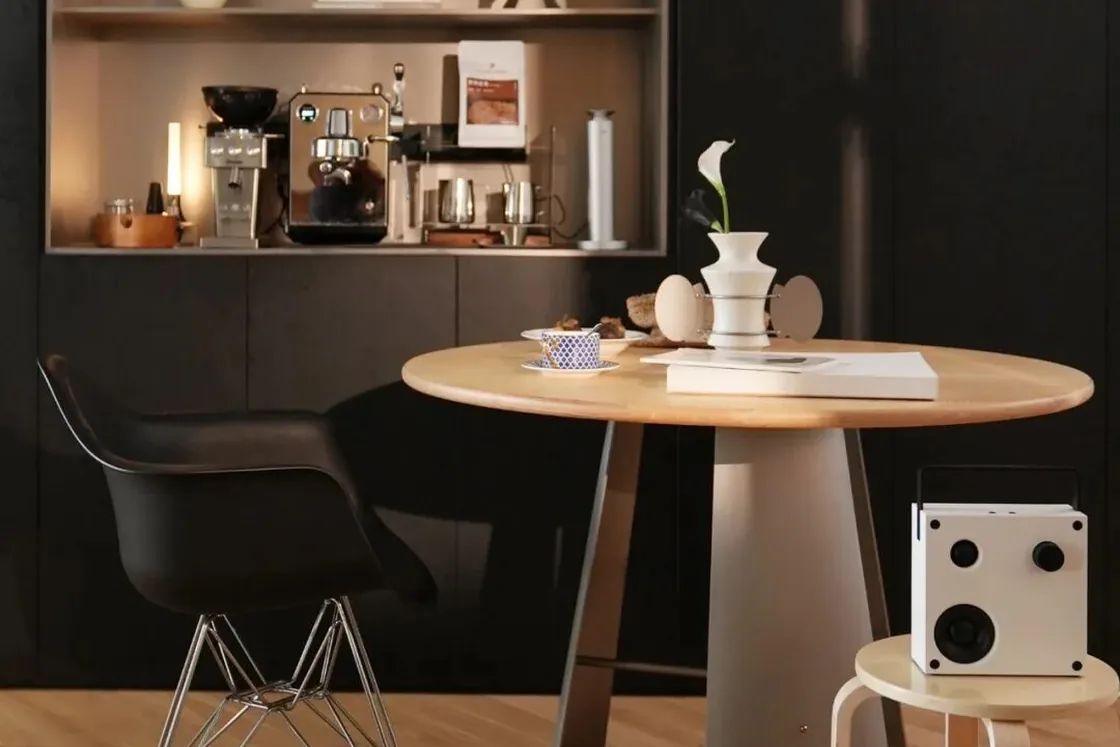 Round wood pedestal table in a warm dining corner