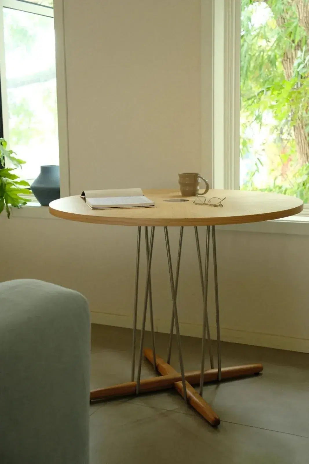 Restaurant Table Sizes and Seating Capacity Guide 19 Round wood dining table beside a tall window