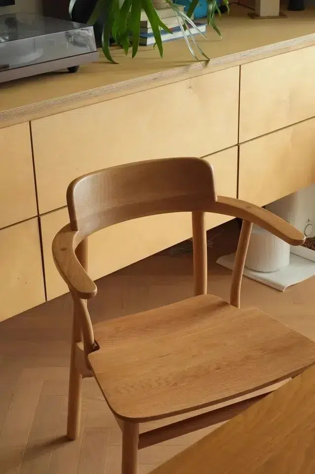 Solid Wood vs Wood Veneer for Furniture Projects 15 Curved solid wood chair frame beside a cabinet